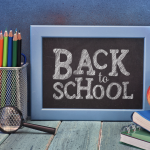 A blackboard with 'back to school' written on it in white chalk
